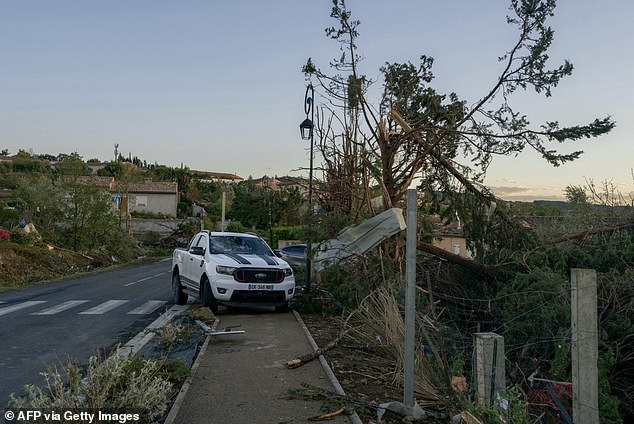 Several roads were closed as fallen trees and cars were strewn across streets