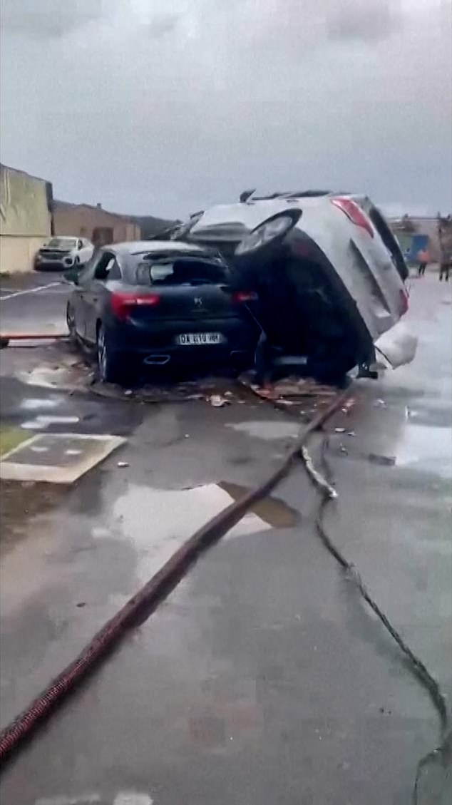 The tornado was strong enough to fling cars and left the pictured vehicle on top of another