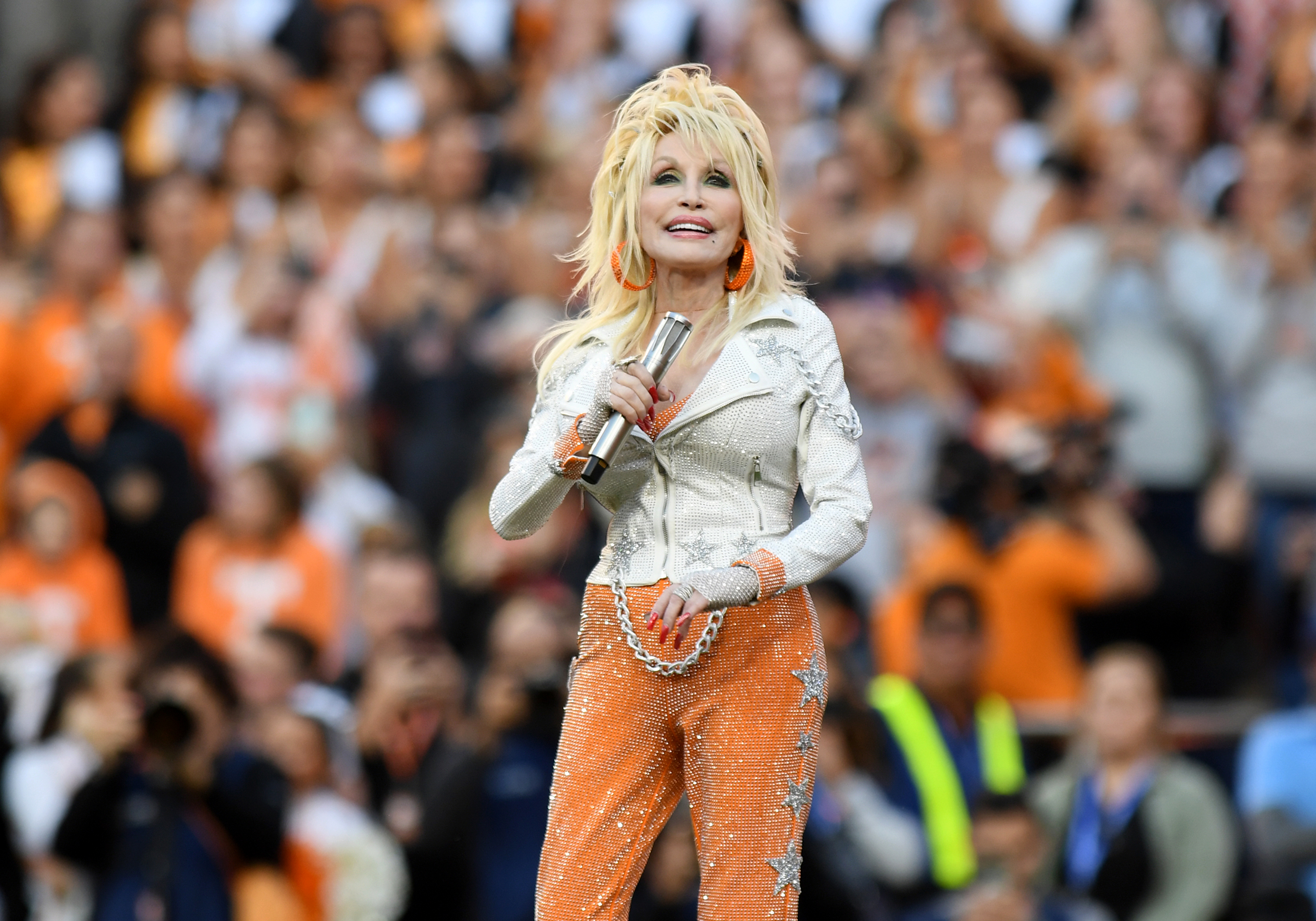 Dolly Parton performs at a college football game.