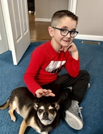 Sigmund Golabek, a child who died in a boating accident, sitting with a small dog.